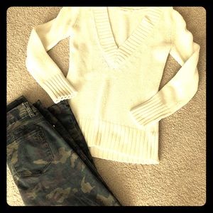 Women’s camo pants and cream sweater